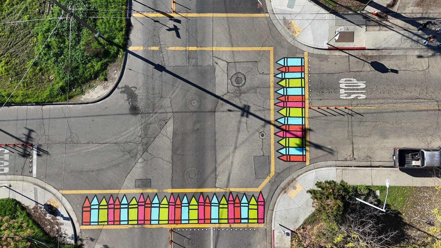 Aerial view of a colorful crosswalk painted across a Selma school intersection