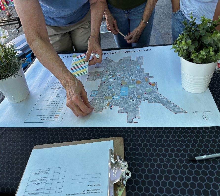 Residents placing pins on a large city map to mark unsafe intersections
